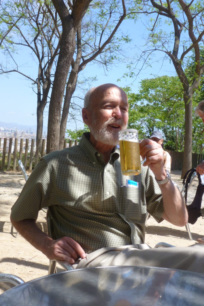 Photograph of John enjoying a beer outdoors in Barcelona. 